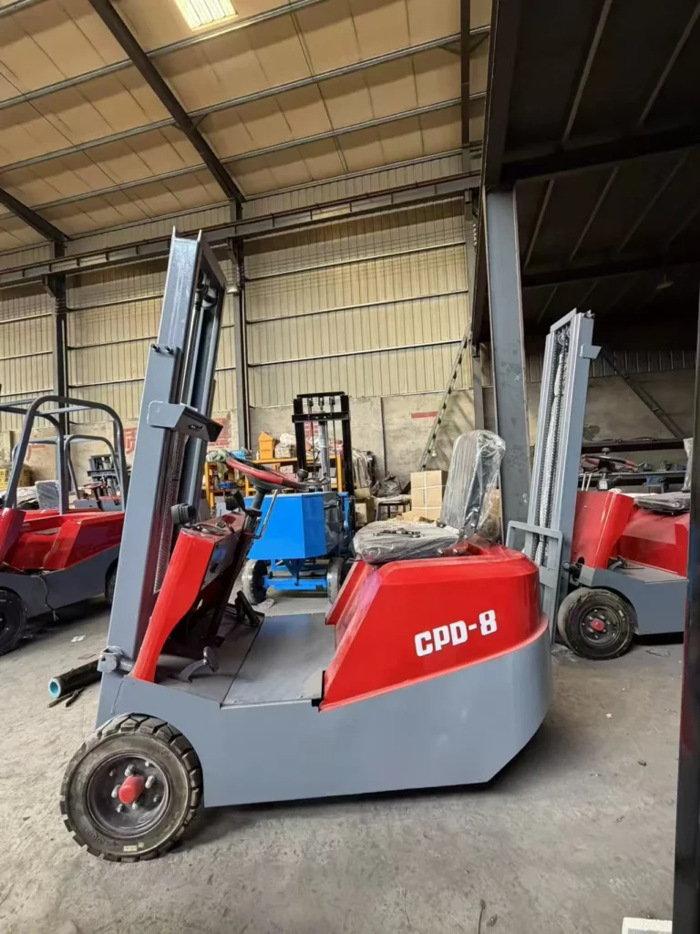 Compact red CPD-8 electric forklift inside a workshop