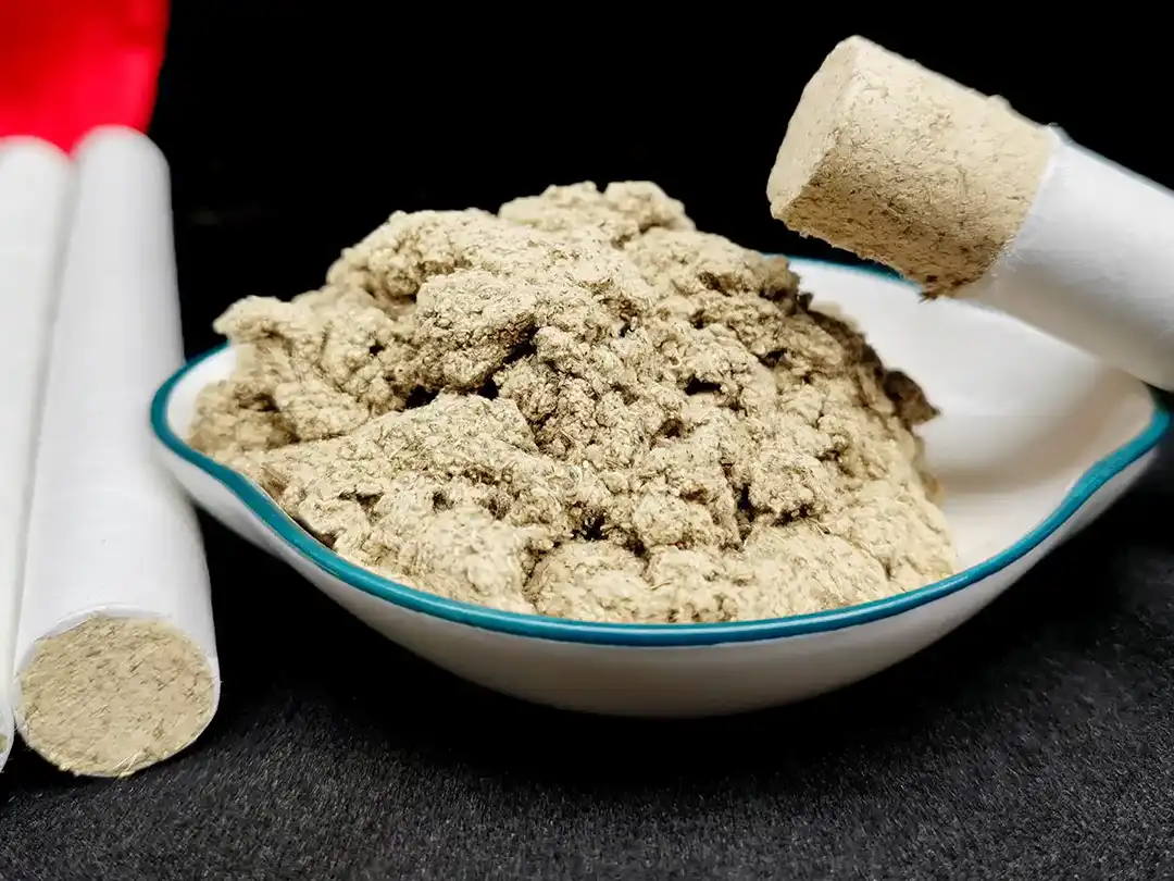 Close-up of cylindrical moxa products and loose fibrous material