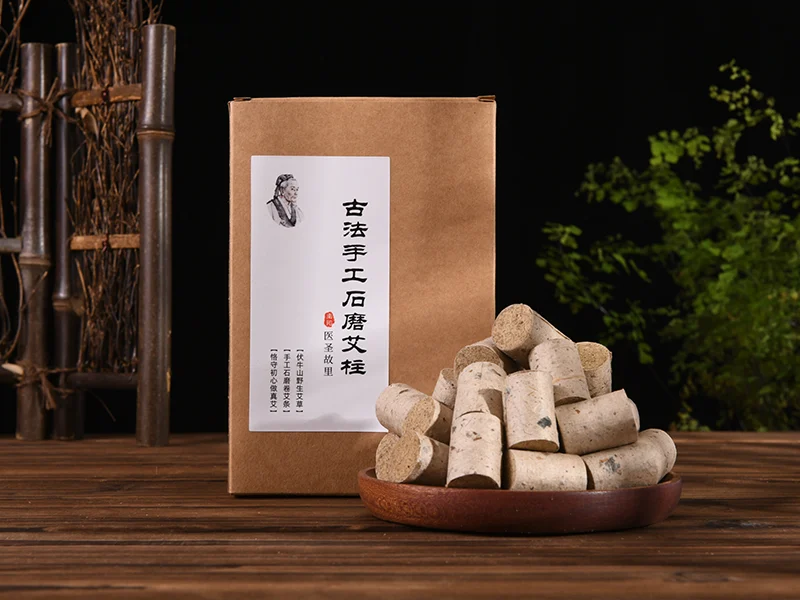 Short cylindrical moxa consumables displayed beside retail packaging
